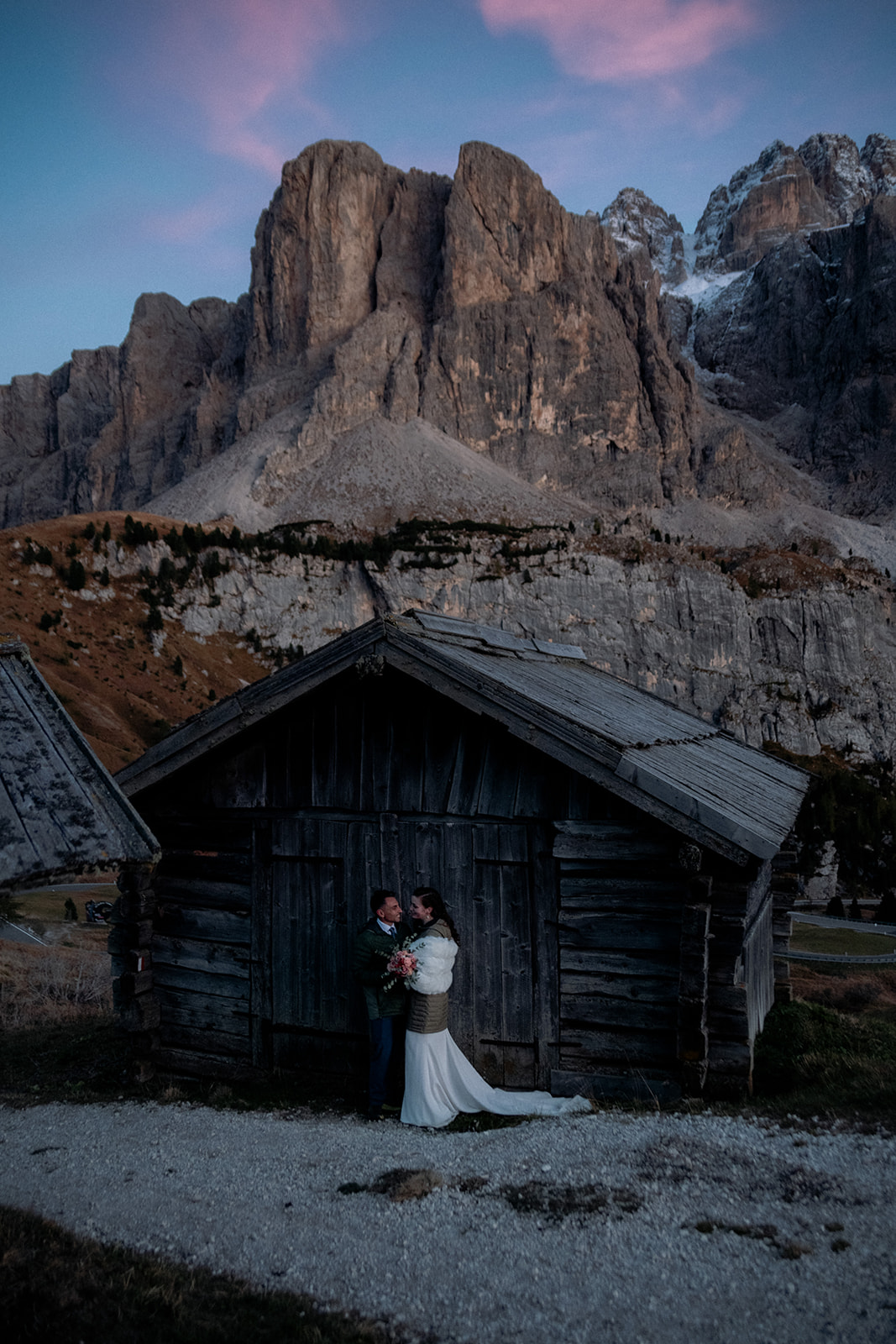 Dolomites elopement photographer - couple in front of a mountain cabin during blue hour